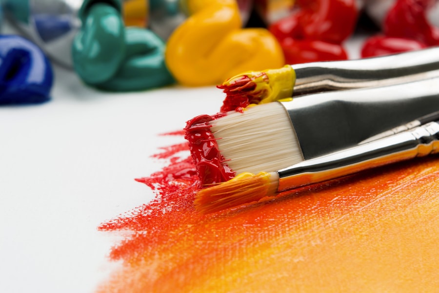 Paintbrushes and wet paint on a canvas