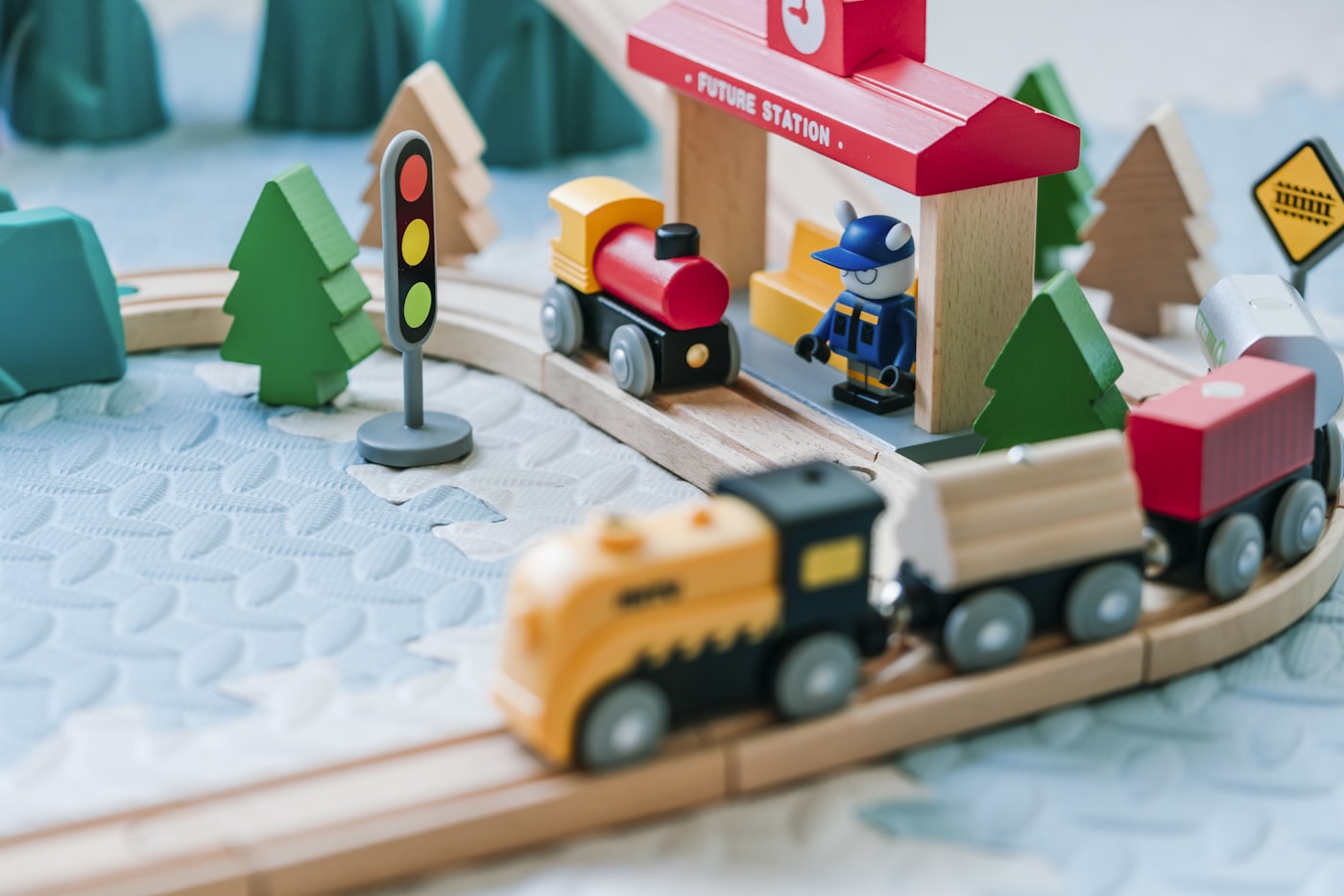 Wooden toy train set on a play mat